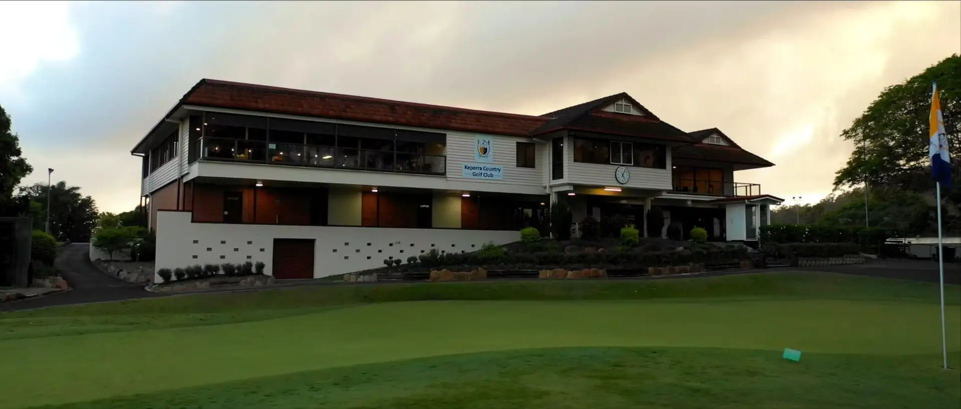 Clubhouse overlooking a practice green at dusk