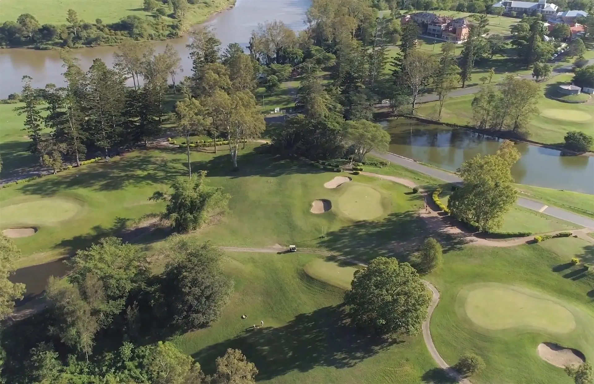 Aerial view of greens, ponds and trees