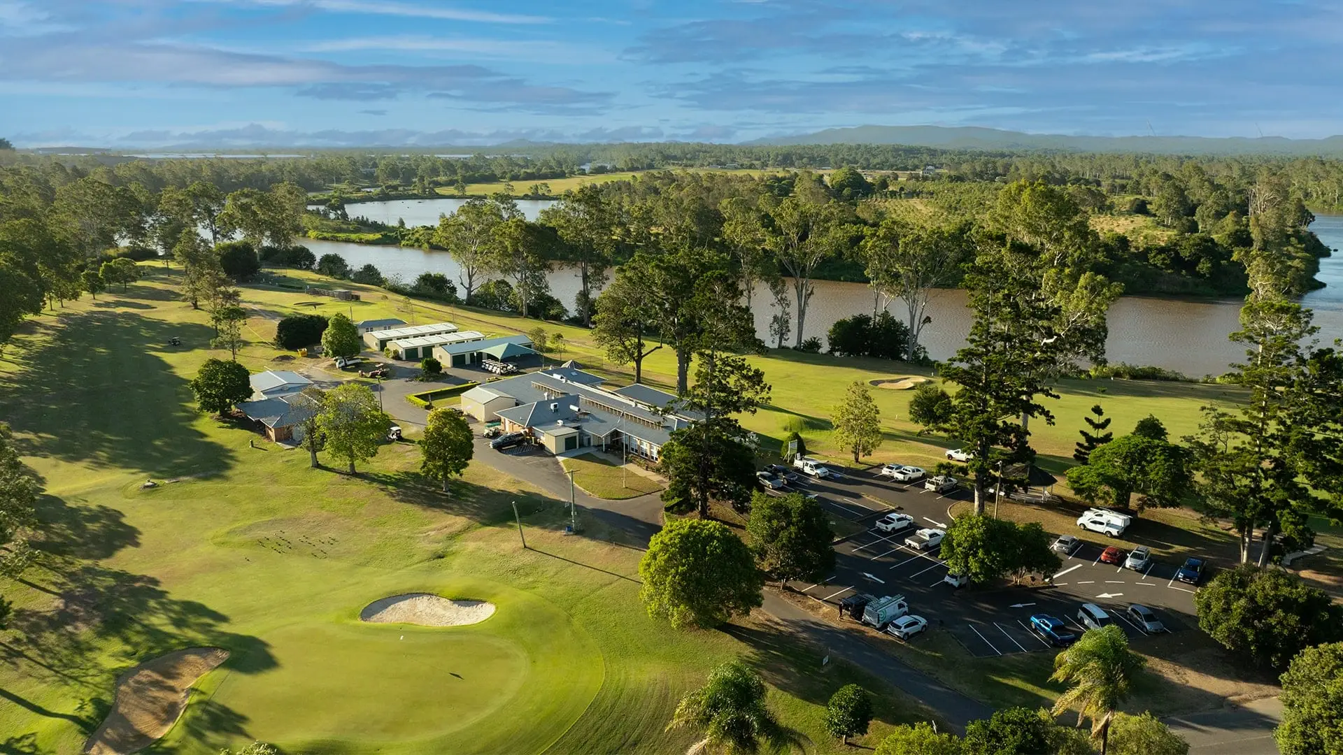 Aerial view of the clubhouse, fairway and river bend