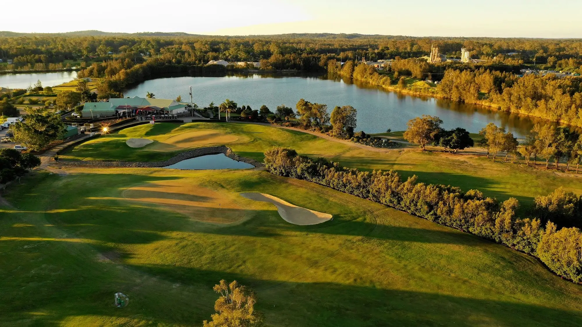 Aerial view of fairways, lakes and clubhouse in golden light