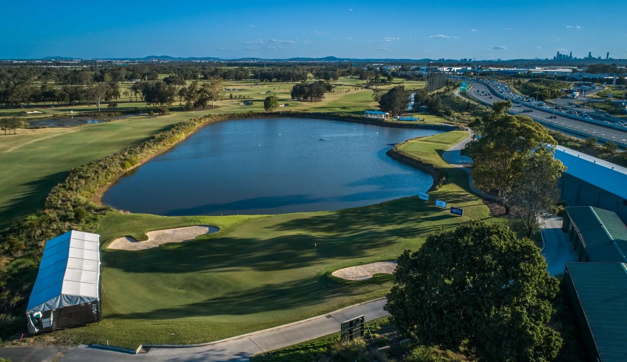 Aerial view of a large lake beside fairways