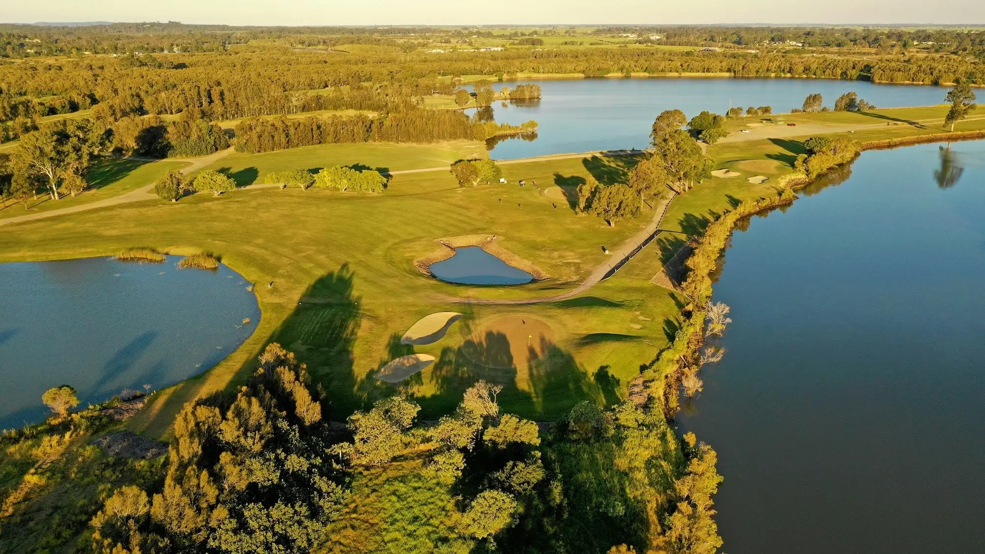 Aerial view of lakes and fairways winding through bushland