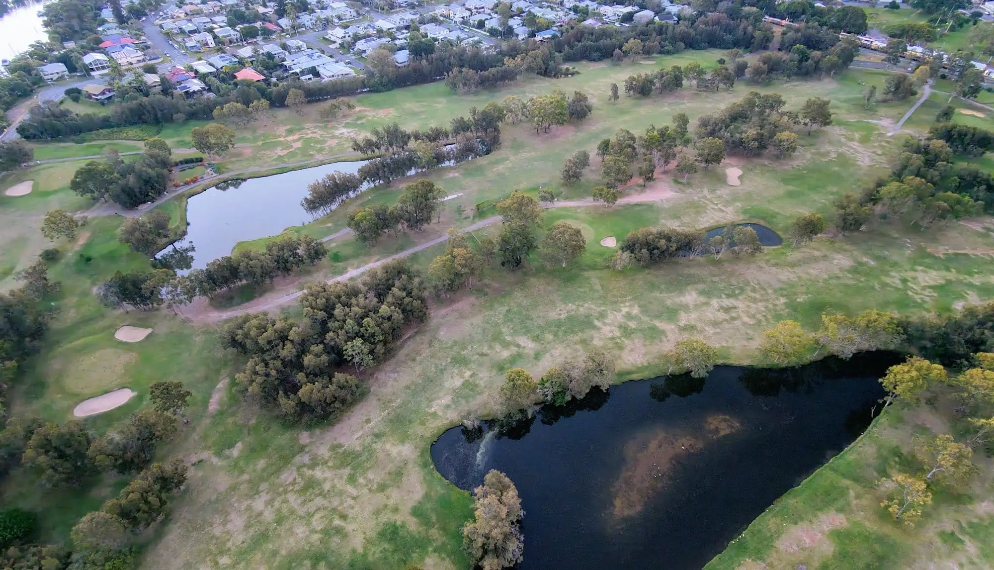 Aerial view of fairways with two ponds among trees