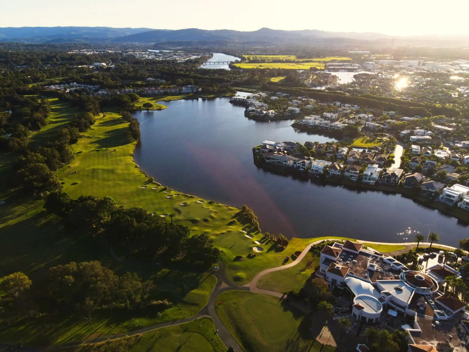 Aerial view of a lake winding through the course and housing