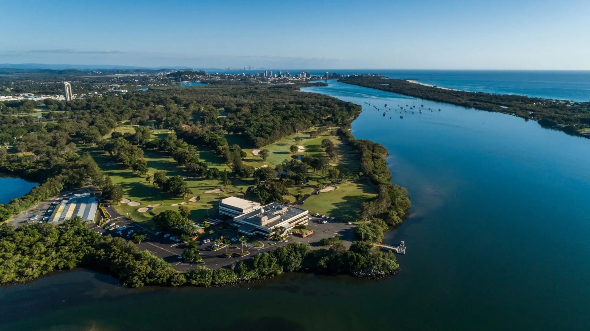 Aerial of course on river peninsula towards the coast