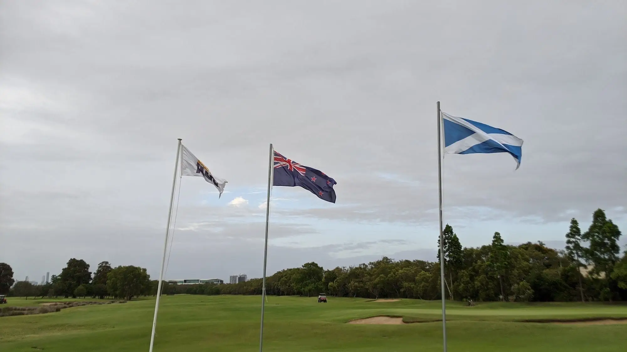 Flags flying above a fairway and bunker