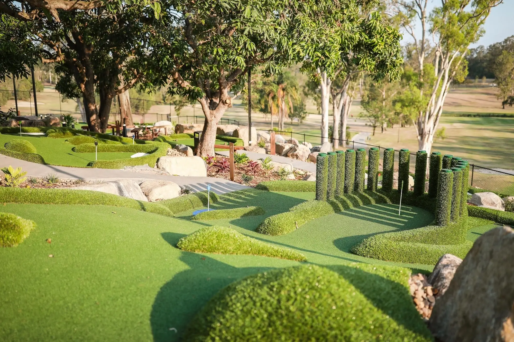 Landscaped putting course with rocks and trees