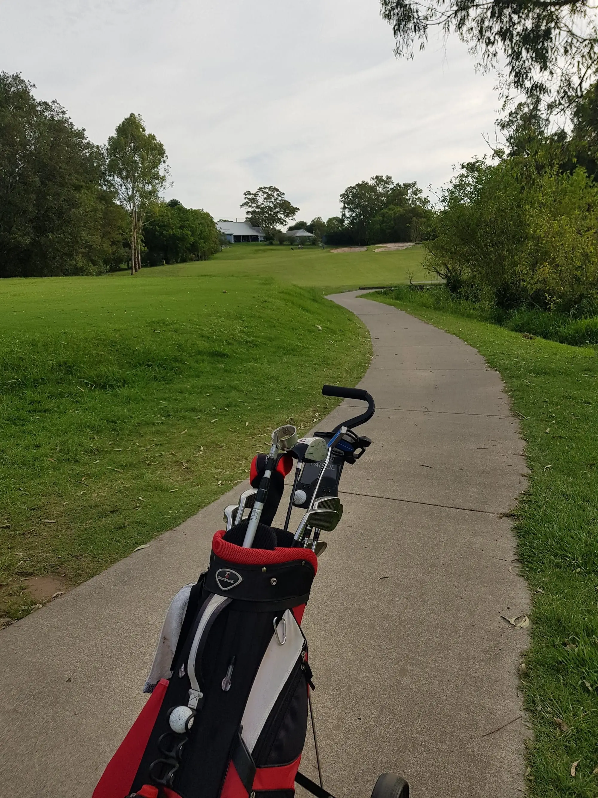 Cart path winding along a fairway toward the green