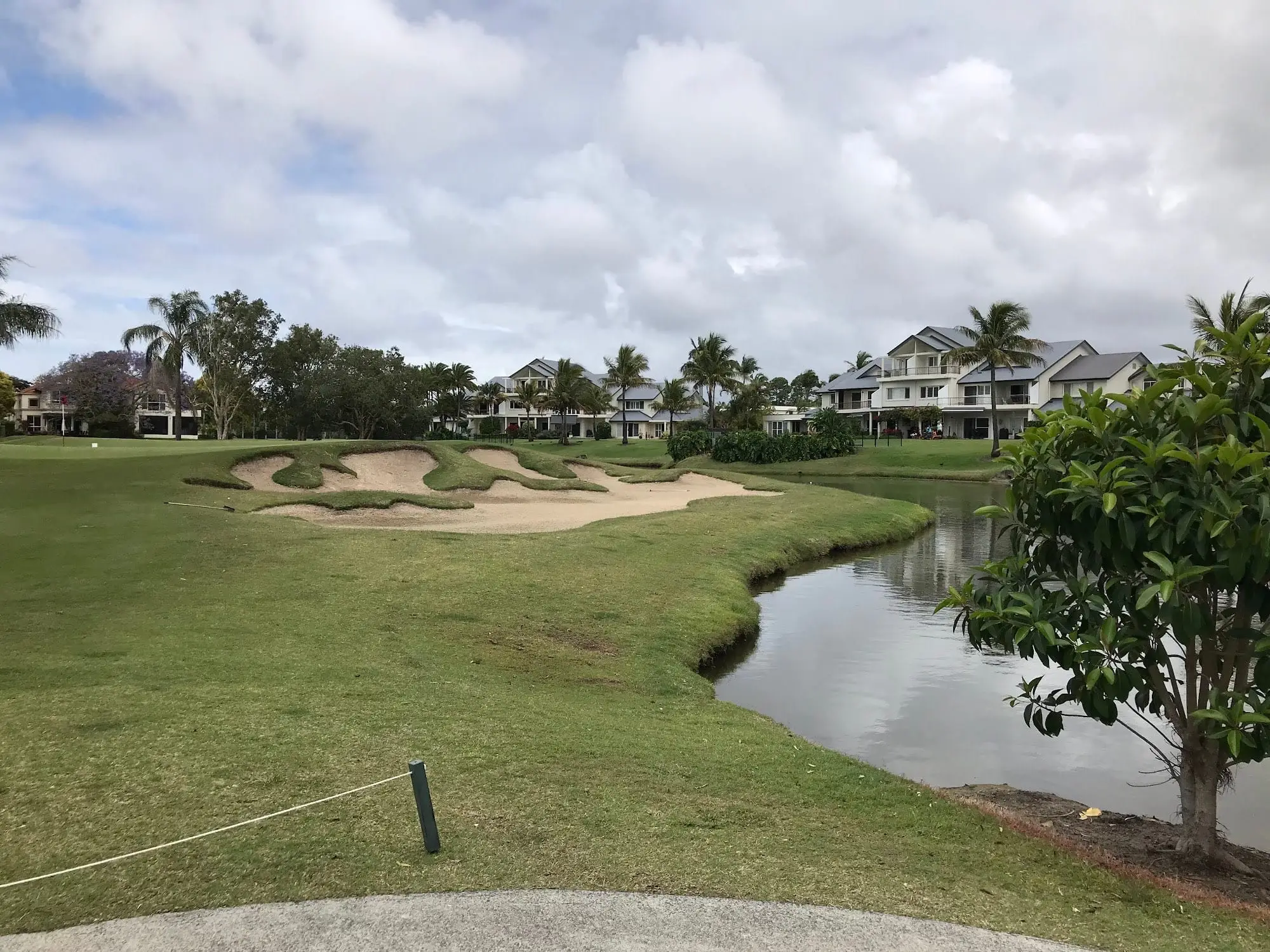 Bunker and creek in front of fairway with villas beyond