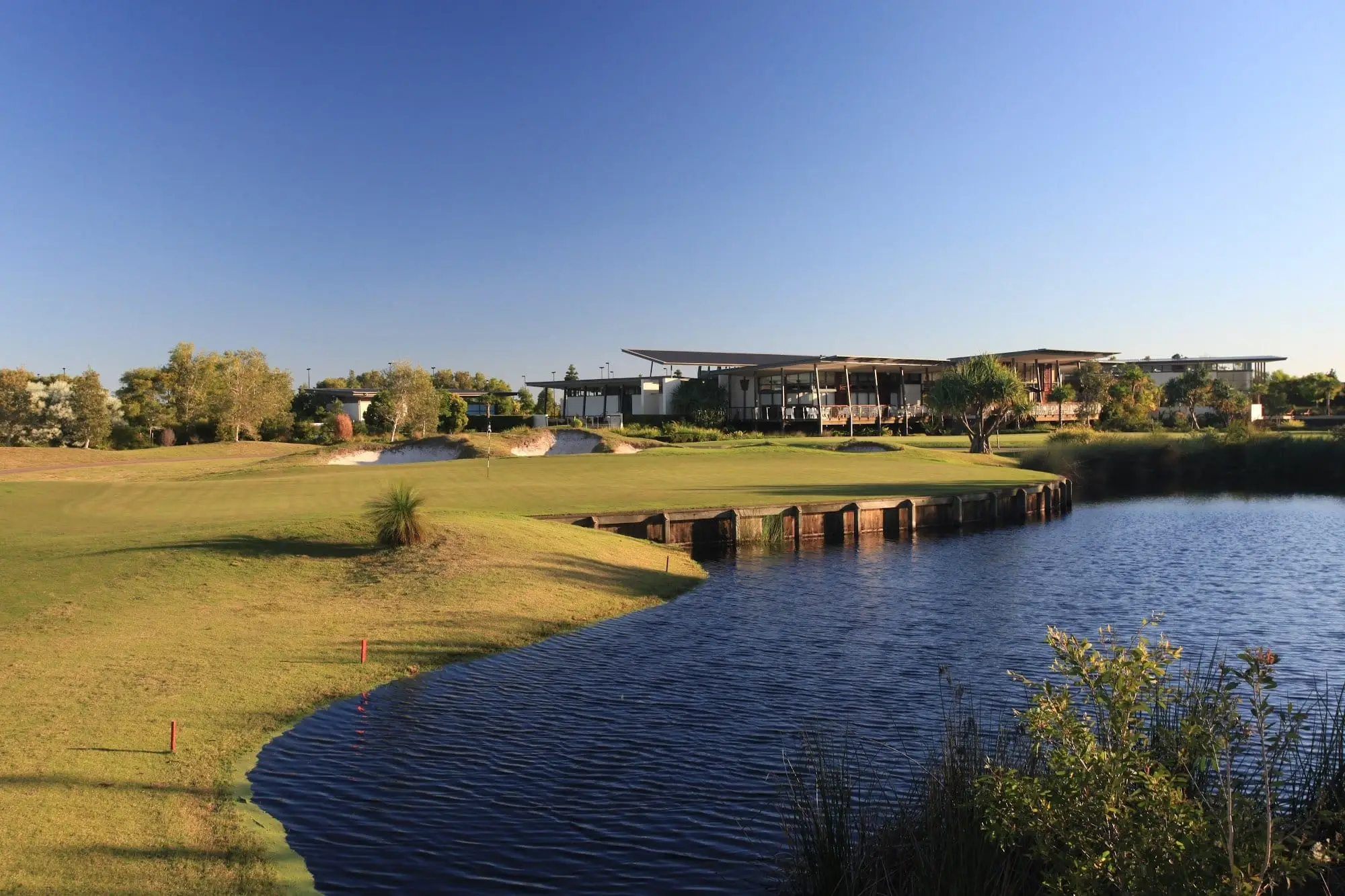 Fairway curving beside a lake toward the clubhouse