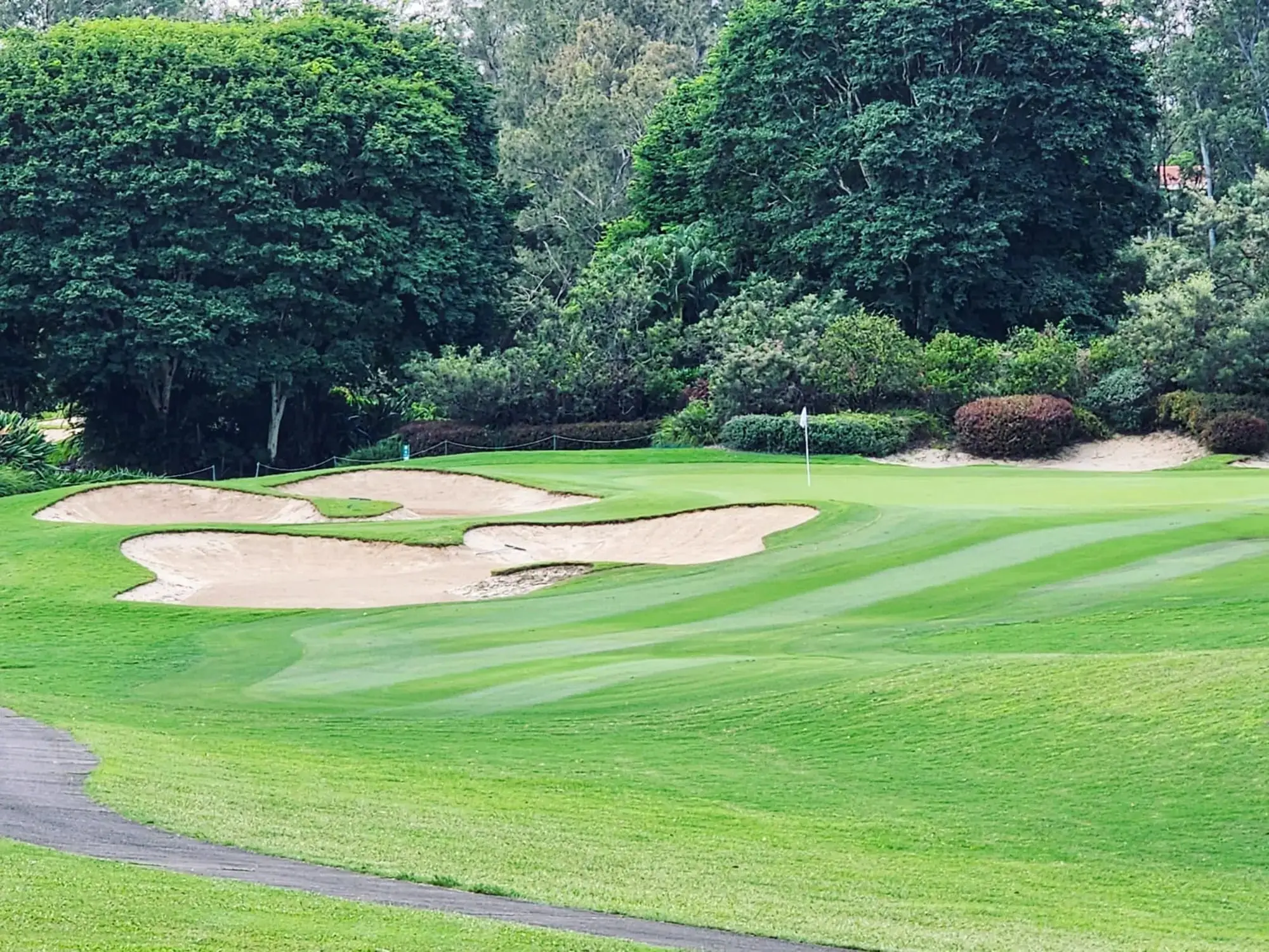 Striped fairway and sand bunkers around a green