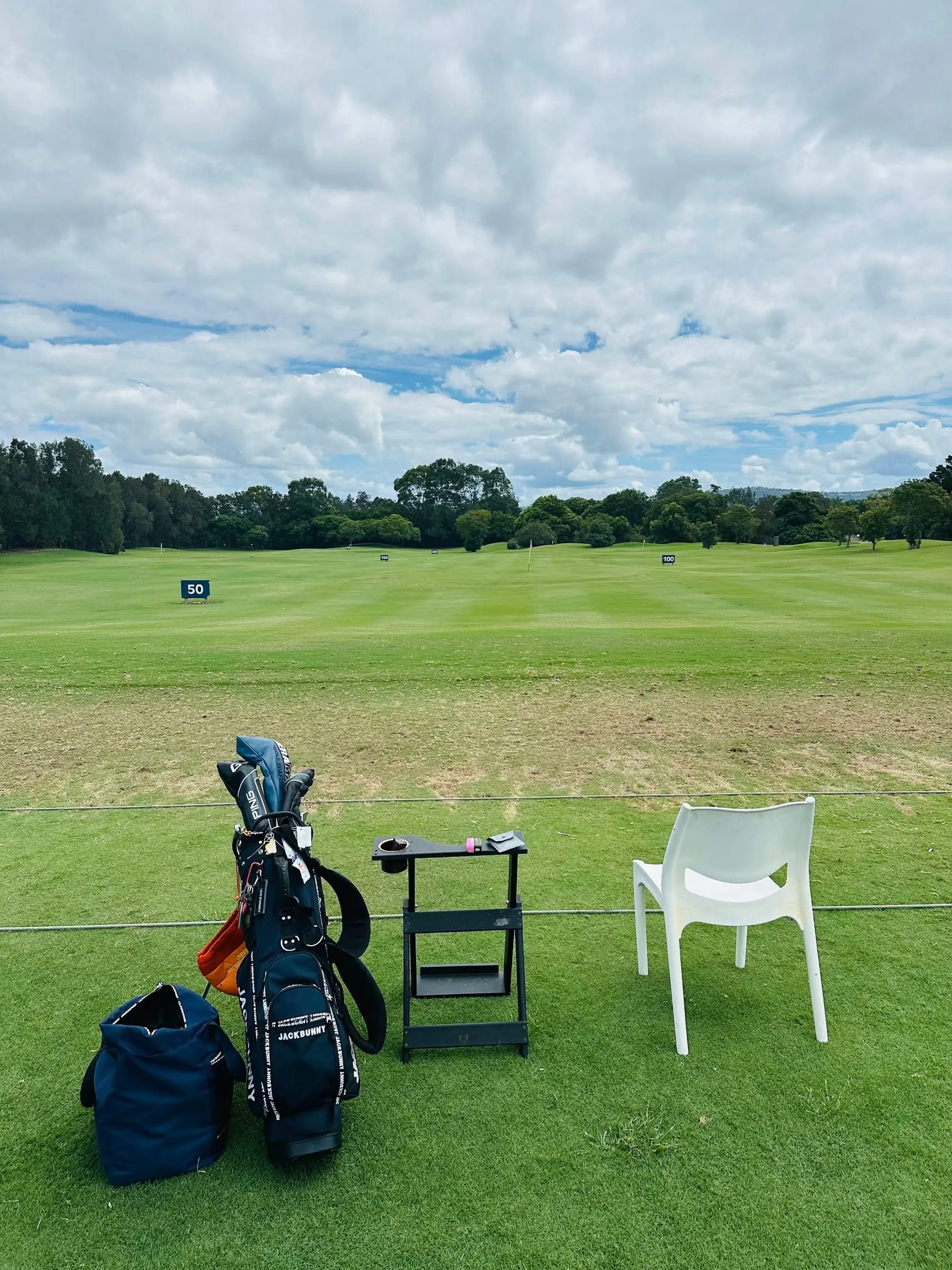 Driving range with distance markers and mown grass