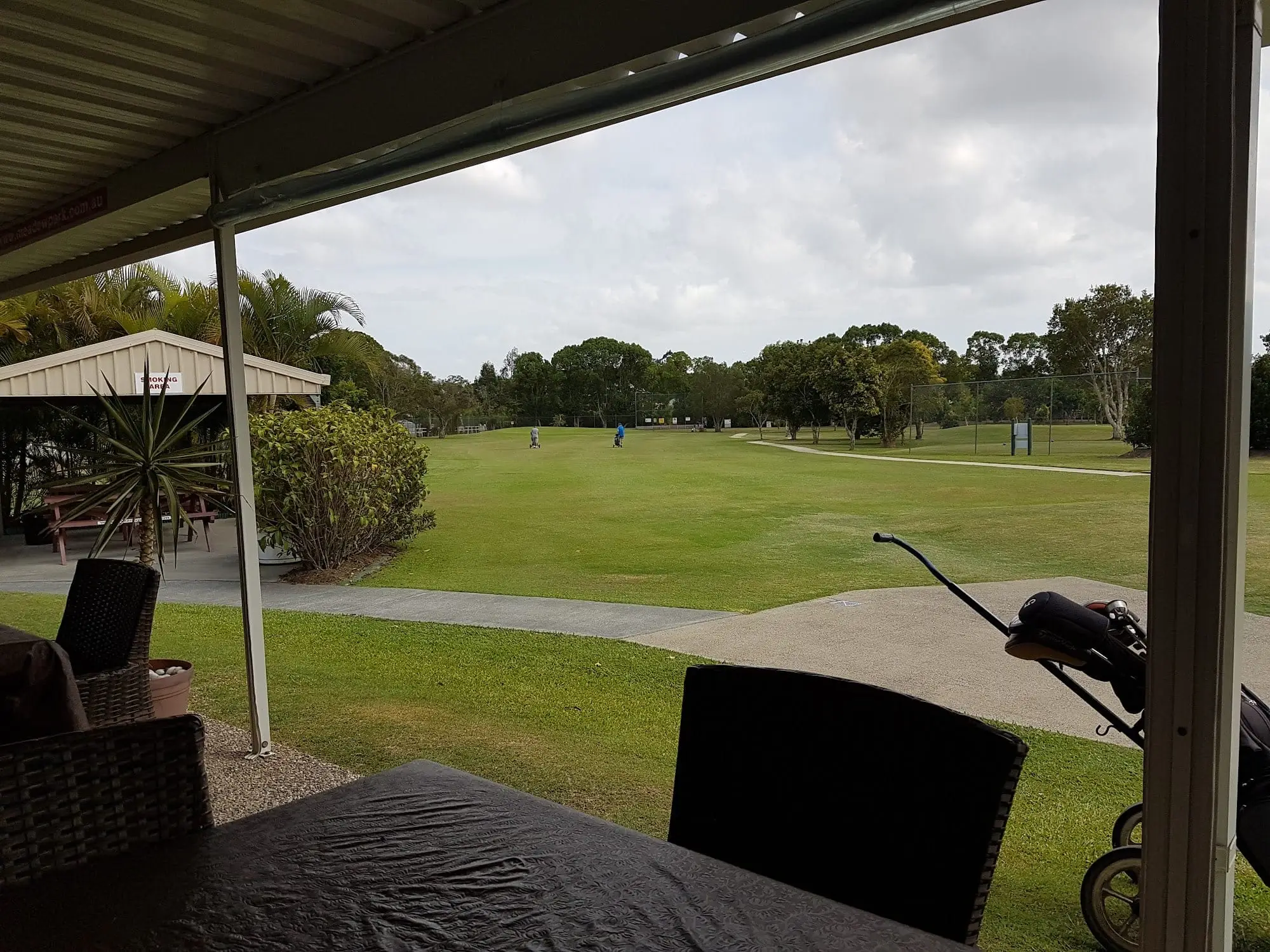 View over the fairway from a covered clubhouse patio