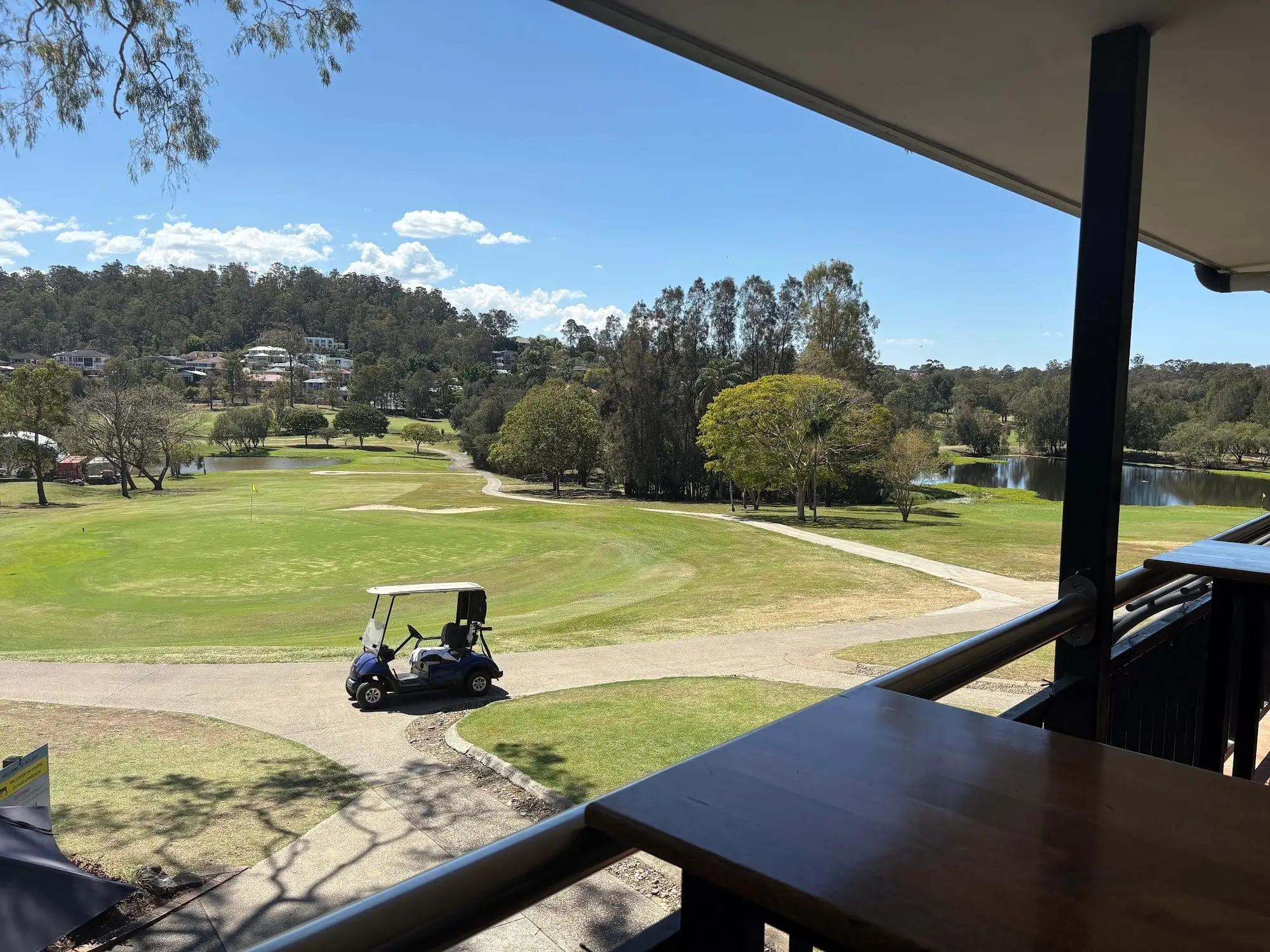 View from the clubhouse balcony over fairway, buggy and lake