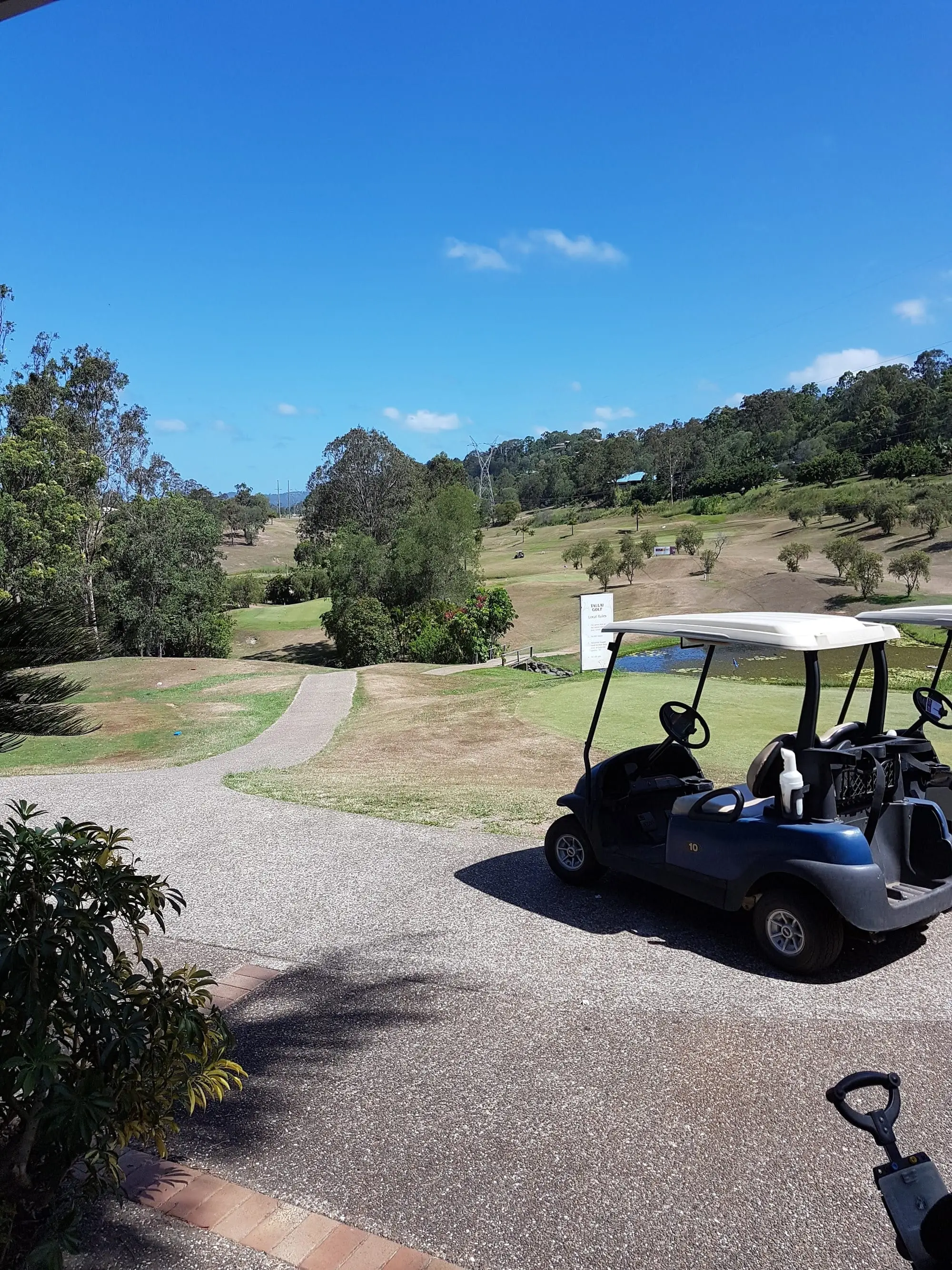 Gravel path and fairway across a hilly course
