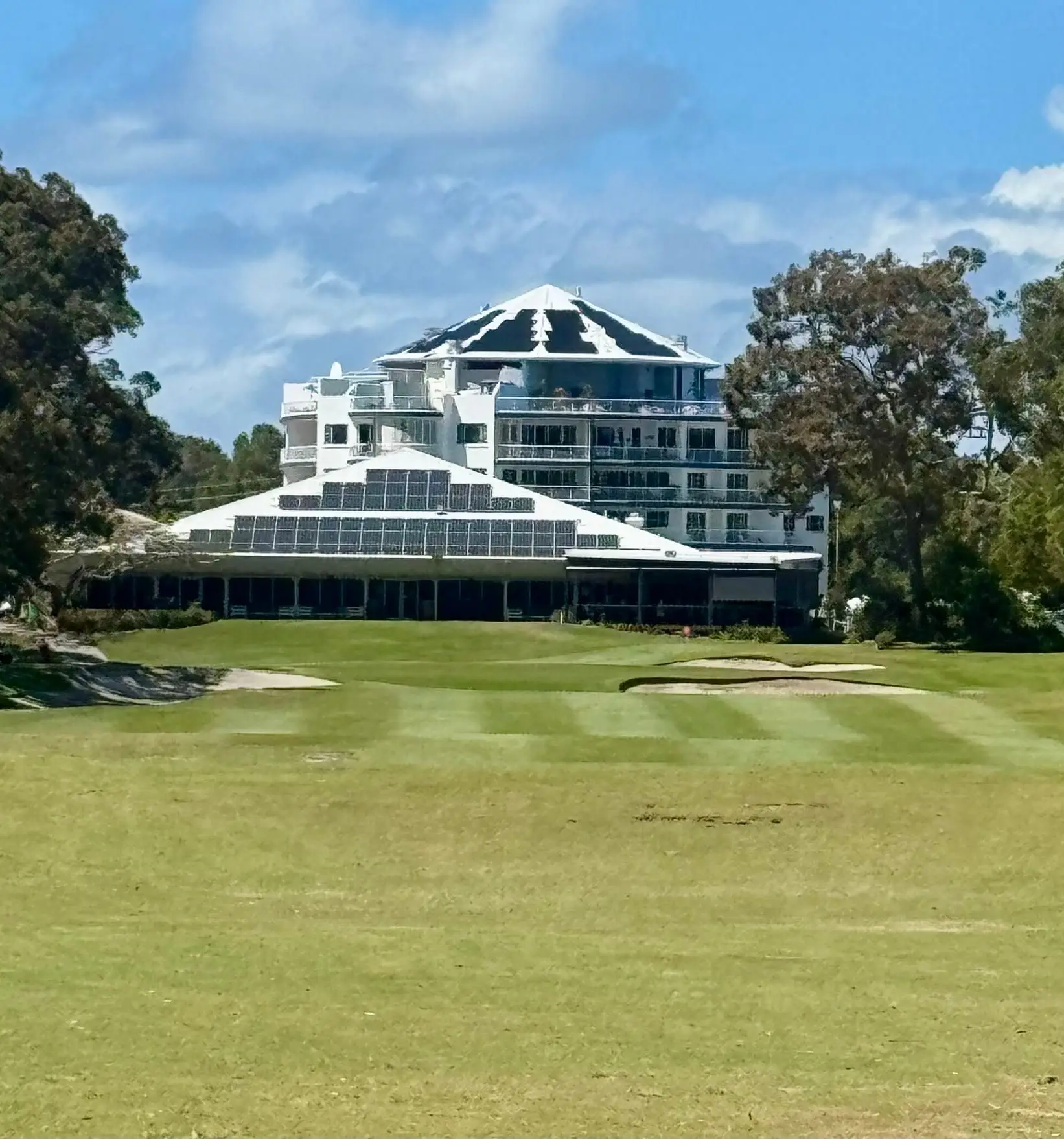 Fairway and bunker in front of the multi-storey clubhouse