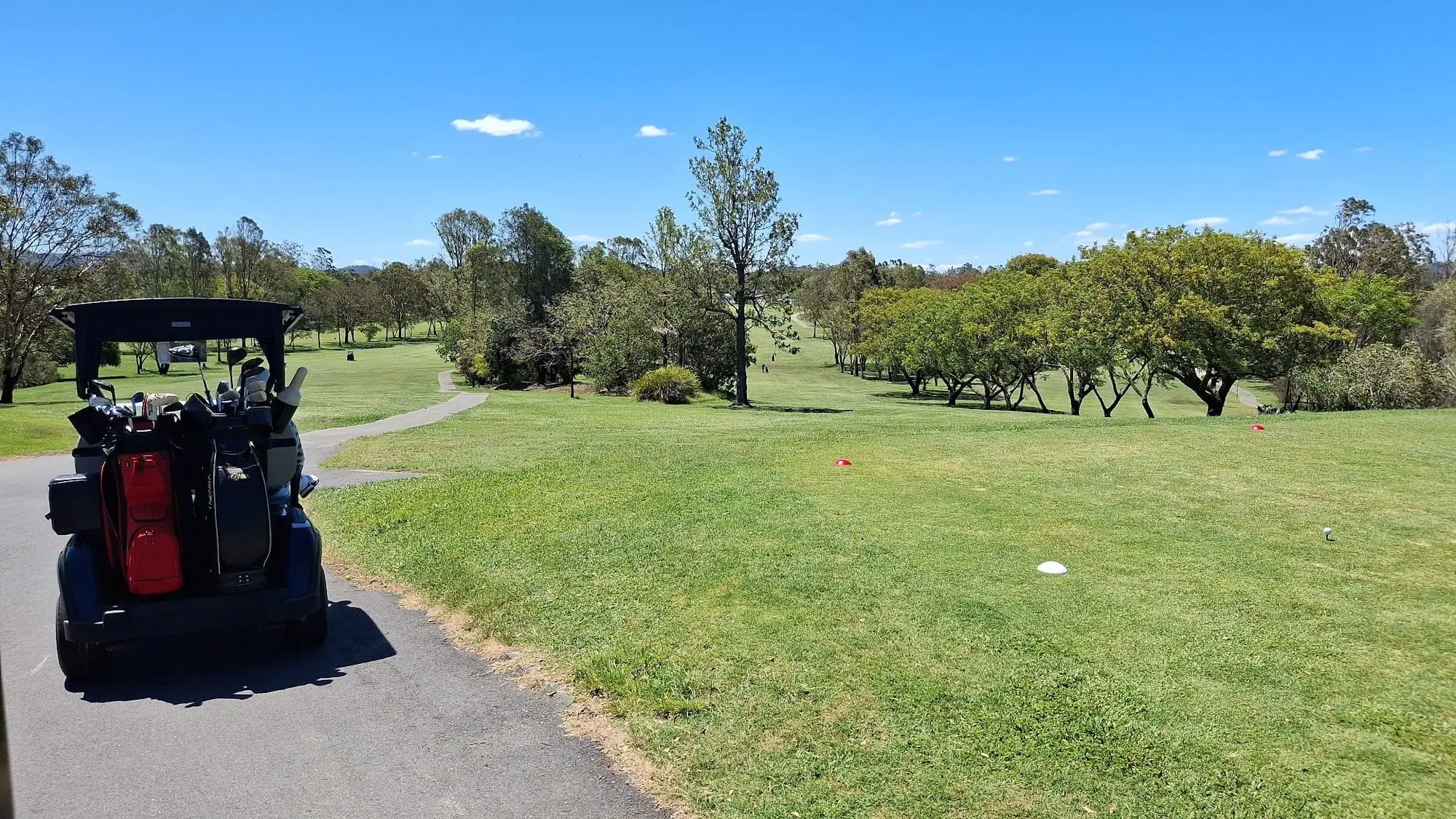 Tee and fairway with a golf buggy on the left