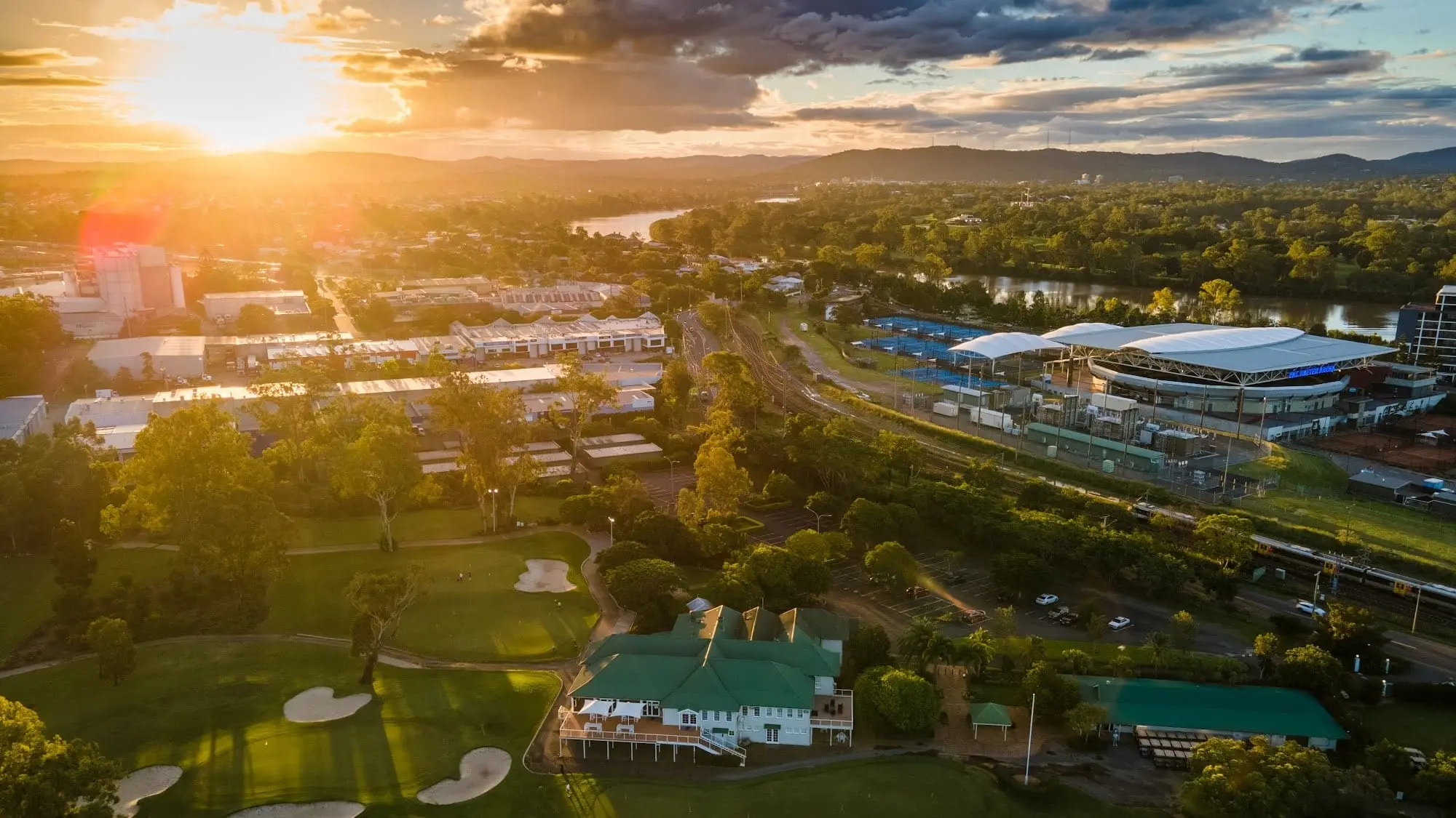 Aerial view of clubhouse and fairways at sunset