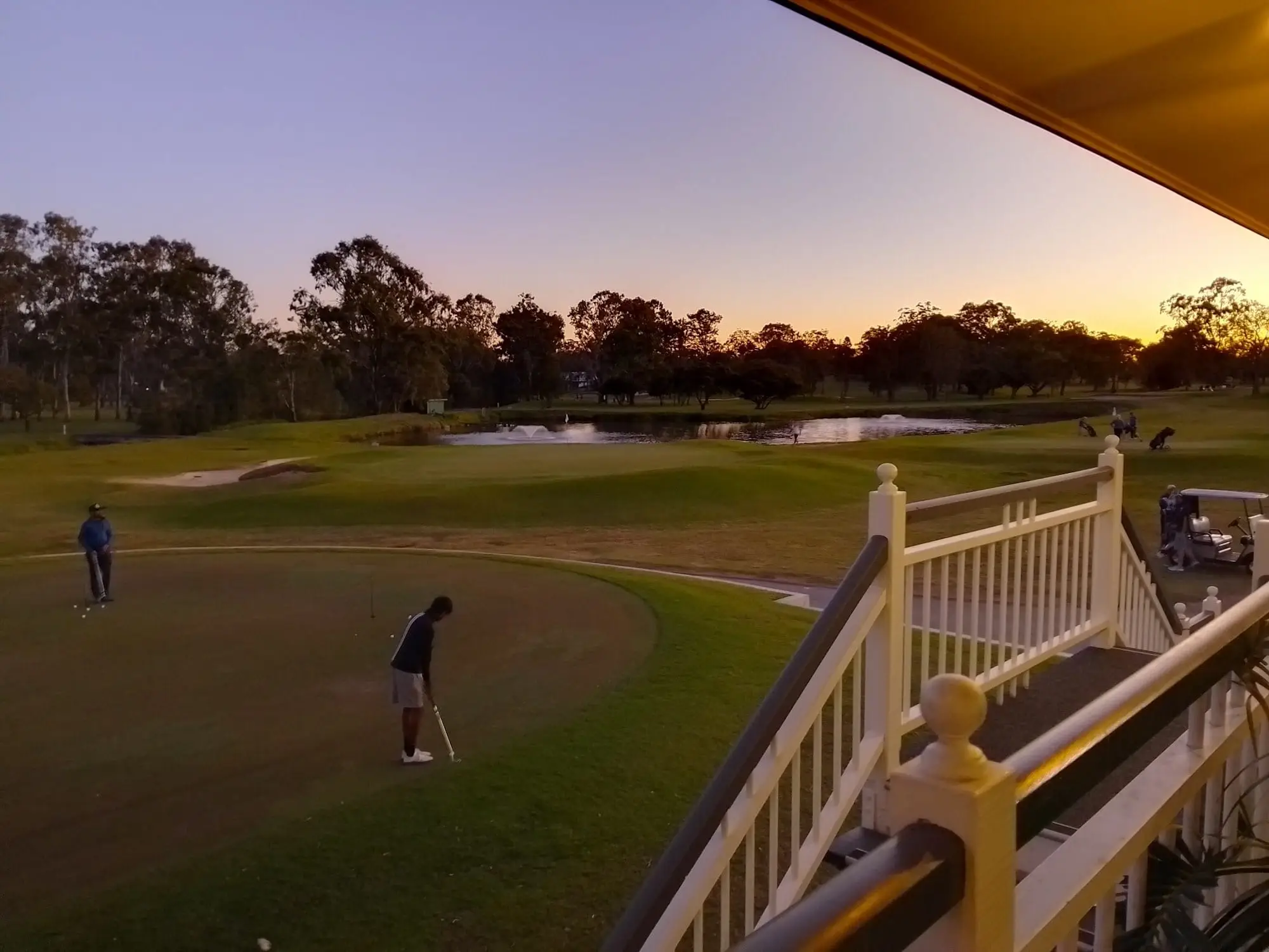Course and pond at dusk viewed from clubhouse veranda